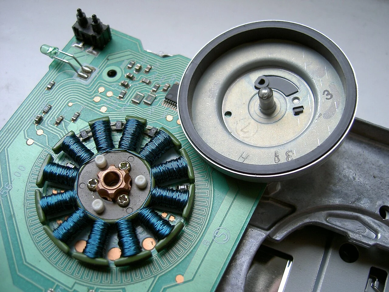 A disassembled brushless motor showing stator coils and Hall sensors