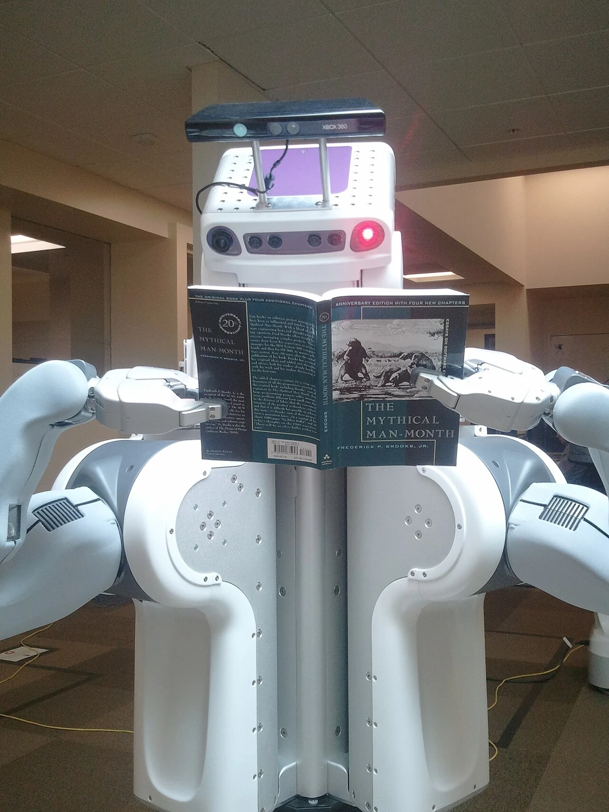Willow Garage PR2 robot holding a book