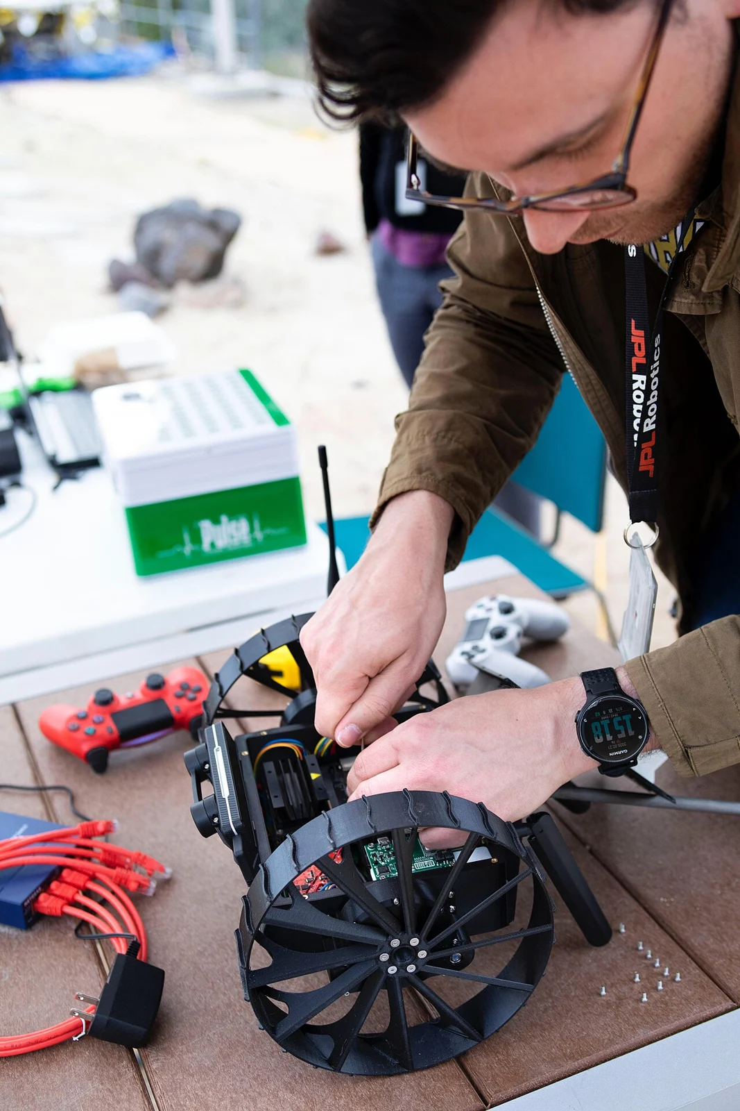 An engineer working on NASA's A-PUFFER rover